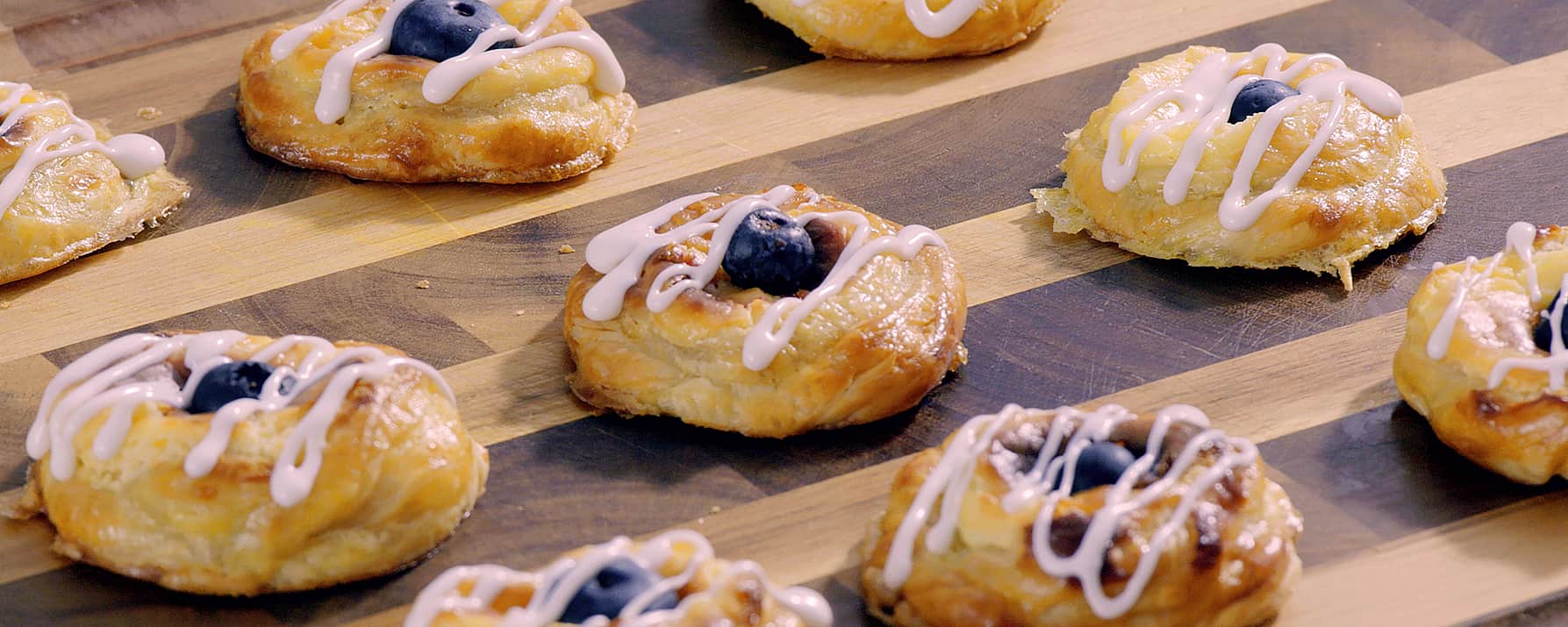 Cream cheese & berry danishes baked in a toaster oven are cooling off on the cutting board
