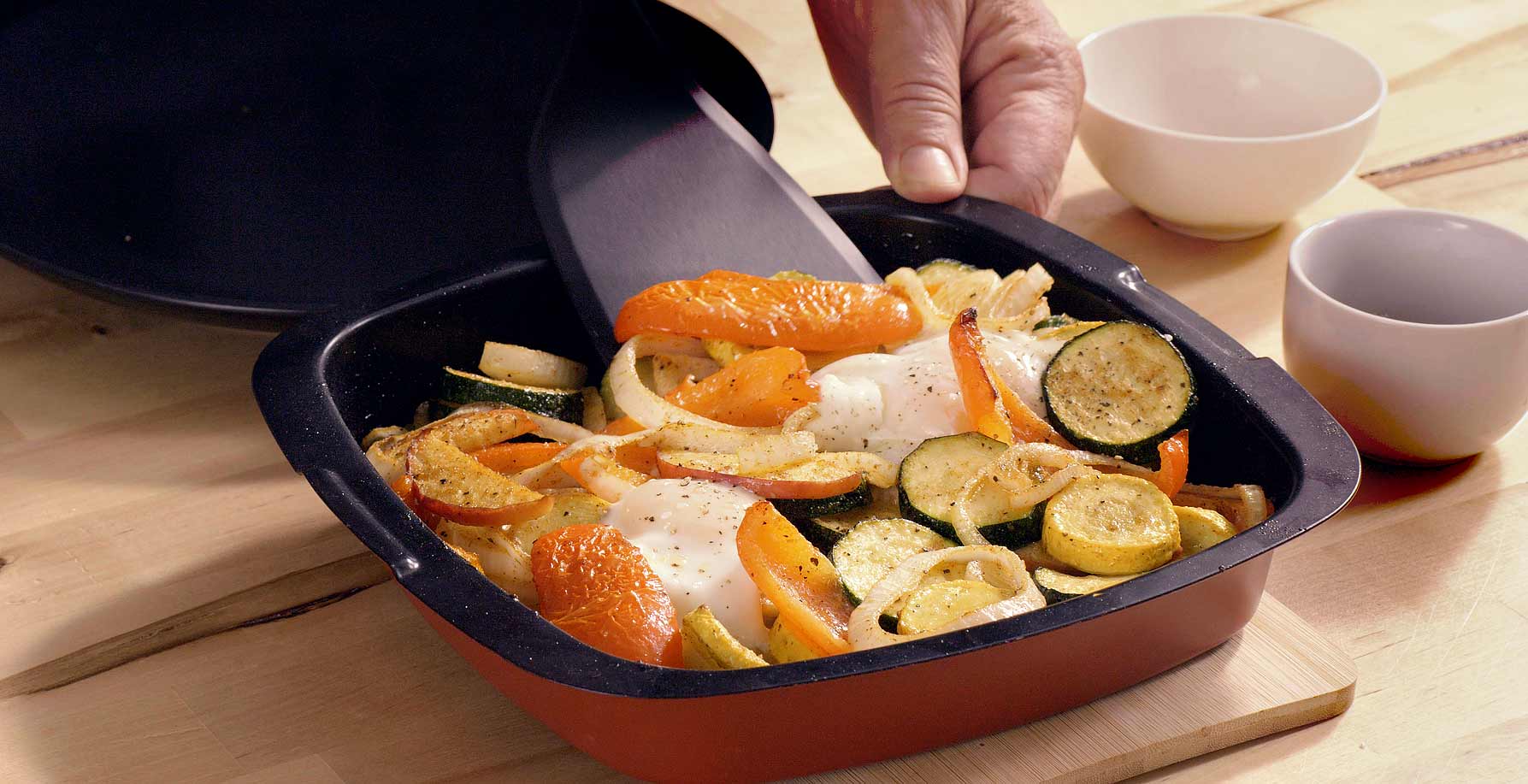 Taking cooked healthy breakfast out of the HeatMate flat pan with a turner